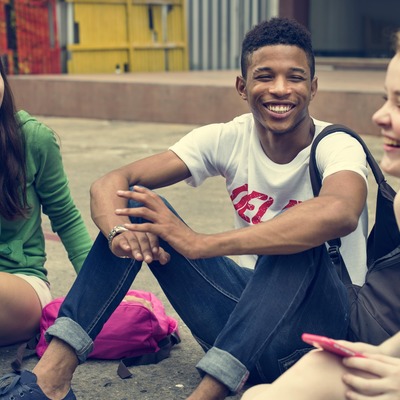 Group of happy young people talking and laughing