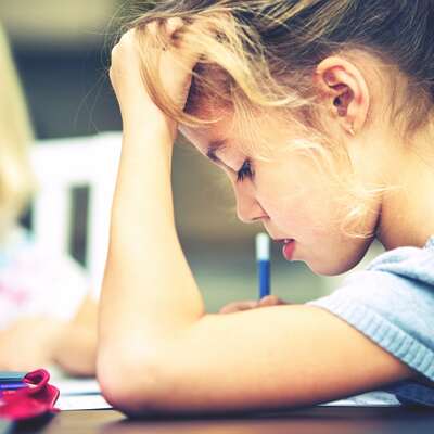 Young girl concentrating on school work